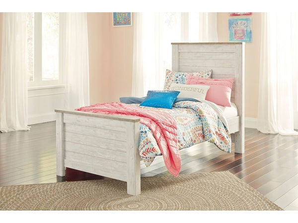 White Ashley Willowton twin bed with colorful bedding in a bright bedroom