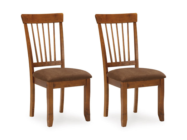 Two wooden chairs with brown cushioned seats on a white background