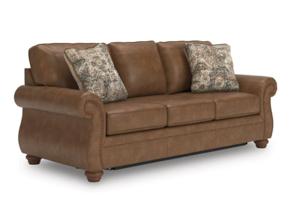 Ashley Chasemoor brown faux leather sleepr sofa with patterned cushions and nailhead trim.